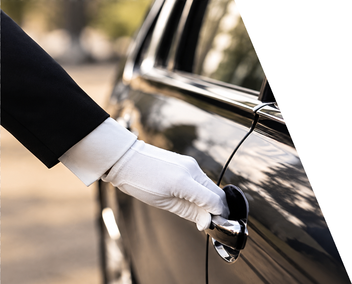 White-gloved chauffeur opening a Mercedes door